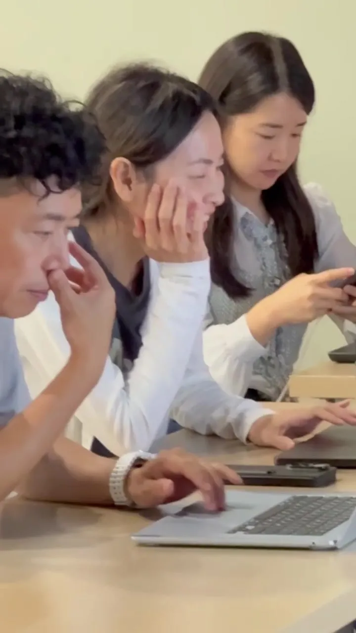 Three participants each working on their own laptop