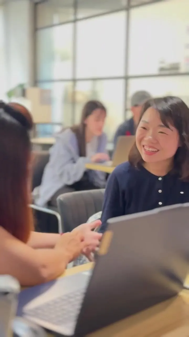 A participant smiling as she talks with her group