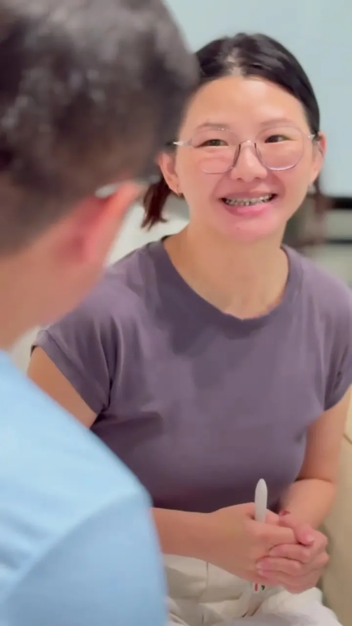 A participant smiling as she talks with her group