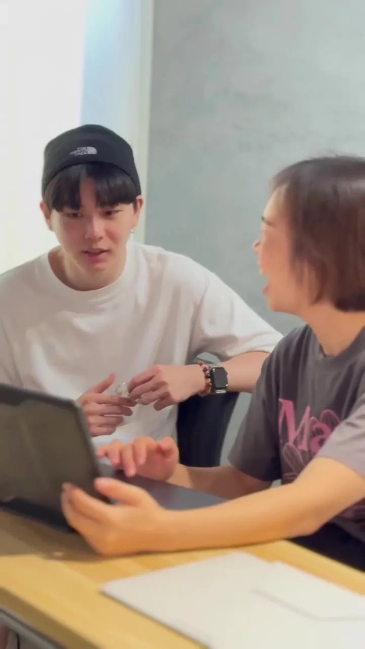 Two participants talking over a laptop